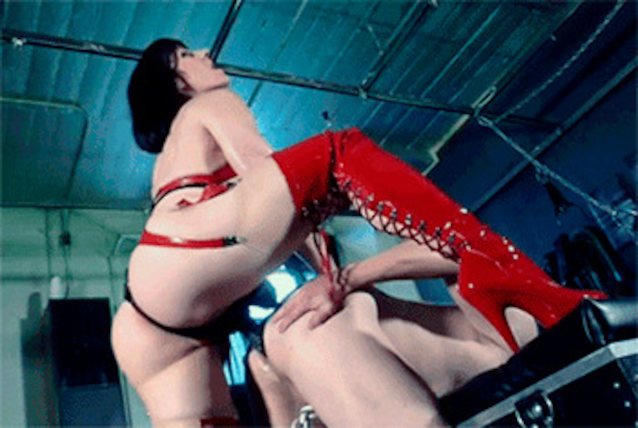 Femdom wearing red latex fucking man in the ass 