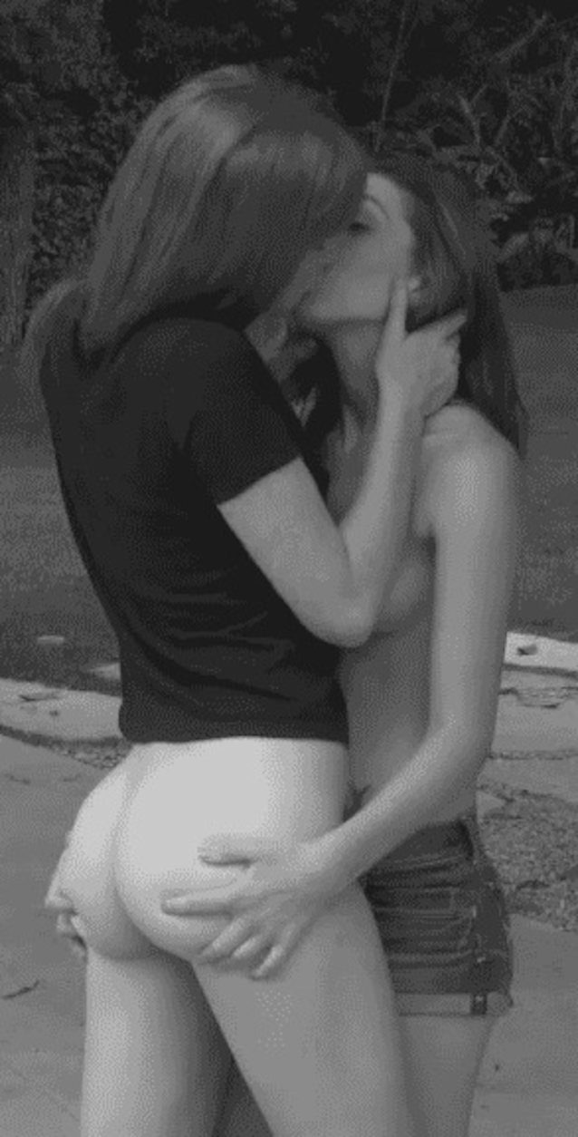 Two foxy lesbians kissing and groping each other