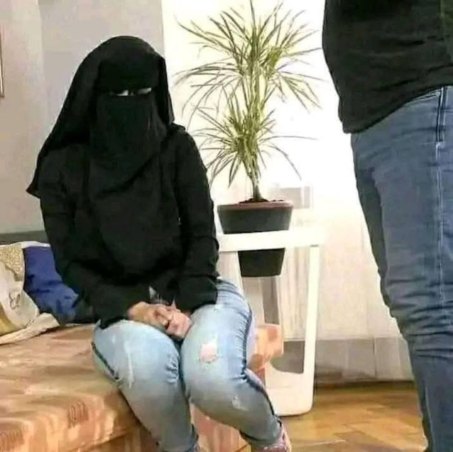 niqab, muslim, face covered, jeans, sitting