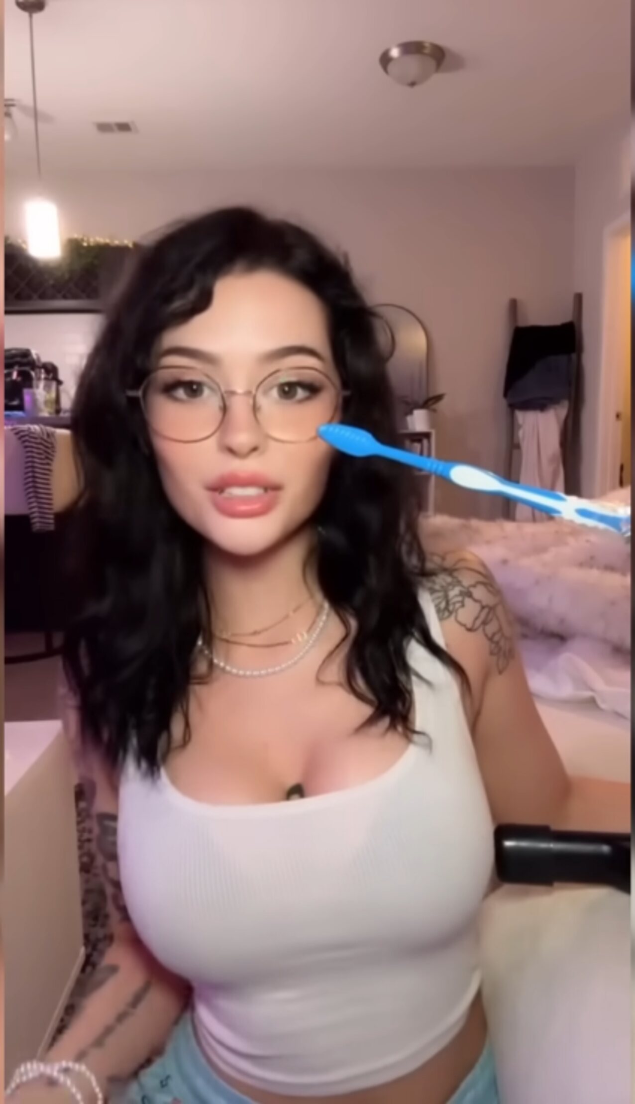 black hair tatooed glasses