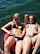 Two girls playing with their pussies together while laying on a floatie in the lake