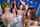 What's the name of the girl standing at the back?