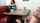 Who is the girl under the table?