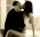 kissing standing brunette